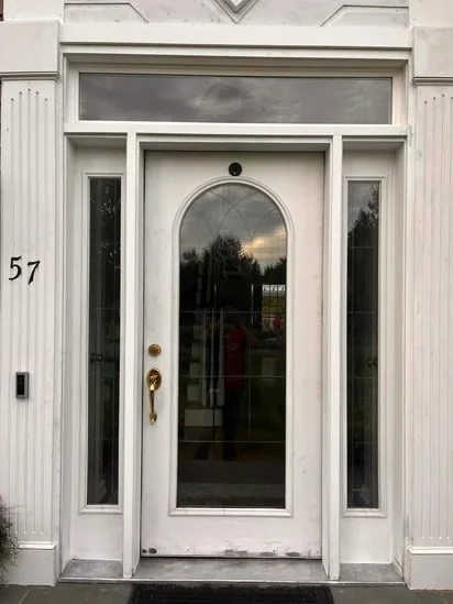 Front door replacement completed on residential house facade.