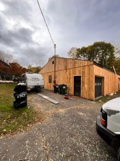 Residential exterior showing freshly installed vertical wood siding.